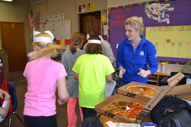 Hannah Walkes serving pizza at Valley Springs Elementary during National Ag Week visits